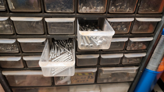 Blue Collar.   Rows of small drawers that hold a variety of screws, nuts and bolts.