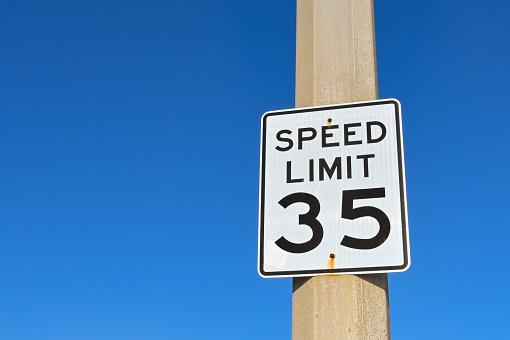 Your Speed, a radar speed sign that displays vehicle speed as motorists approach. 25 mph speed limit sign in residential neighborhood.