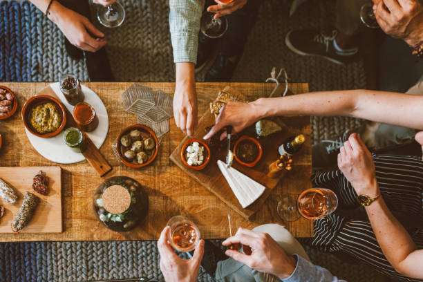 istock top view of people gathering around table - details on appetizers and hands 1470585245