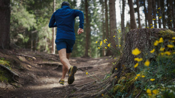 istock Man trail running in a mountain forest 1470586440