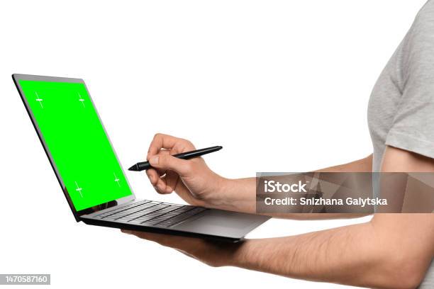 A Man In A Tshirt Holds A Laptop An Ultrabook And Puts An Electronic Signature With His Other Hand Stock Photo - Download Image Now