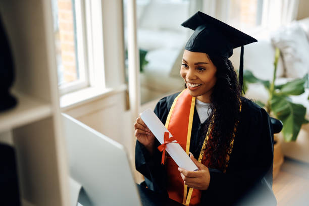 istock Happy black student showing her graduation diploma during a video call. 1470587224