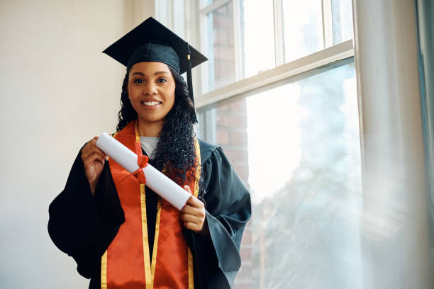 istock Happy black graduate student with her university diploma looking at camera. 1470587312