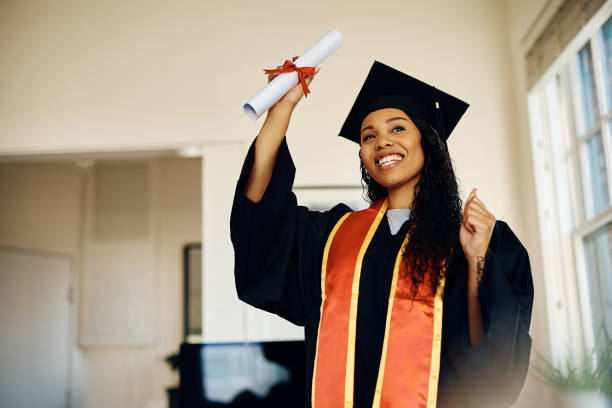 istock Happy black student celebrating her graduation at home. 1470587321