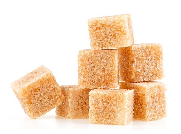 istock Cubes of brown cane sugar isolated on a white background 1470587400