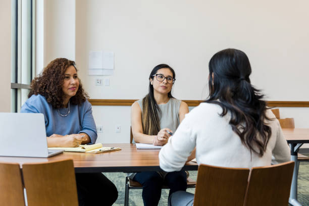 istock Two female managers sit and listen to the unrecognizeable woman answer their interview question 1470587676