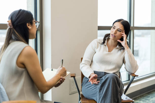istock Distraught young woman talks with her therapist about some issues at work 1470587681