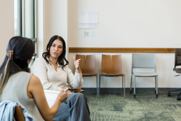 istock Distressed young woman talks with the unrecognizeable female therapist 1470587682
