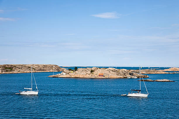 istock Sailboat and rocky coast 147058857