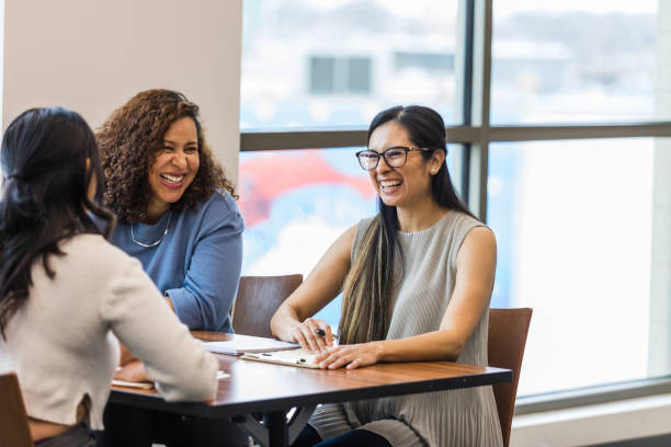 istock Female coworkers sit and enjoy conversation together 1470588627