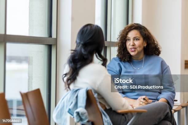 Supervisor Meets With Mid Adult Female Employee To Mentor Her Regarding A New Position She Is Interested In Stock Photo - Download Image Now