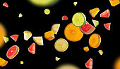 Excellent fruity set flying in space isolated on black background. Pieces of orange, lemon lime and grapefruit glow from inside. High resolution and great retouching.