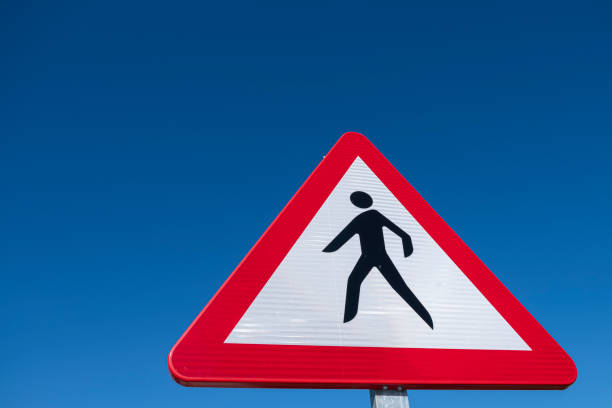 istock Dangerous pedestrian crossing traffic sign over a blue sky 1470591647