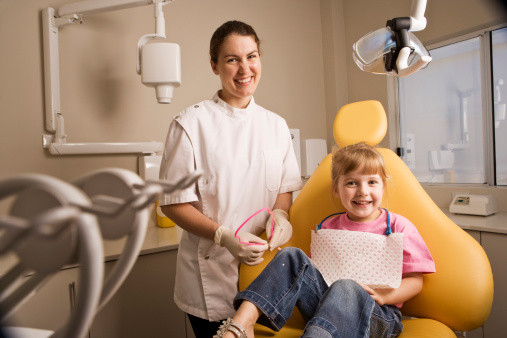 Dentist with little girl patient