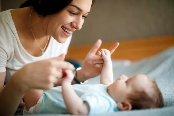 istock Happy mother playing with her newborn baby 1470597757