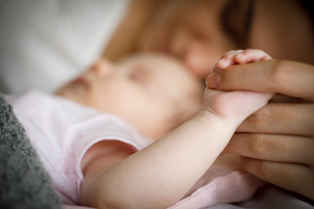 istock Baby holding mother's hand 1470597962