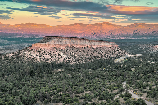 Mesa on the Pajarito Plateau and the Sangre de Cristo Mountains in the distance at Los Alamos, near Santa Fe, New Mexico, USA