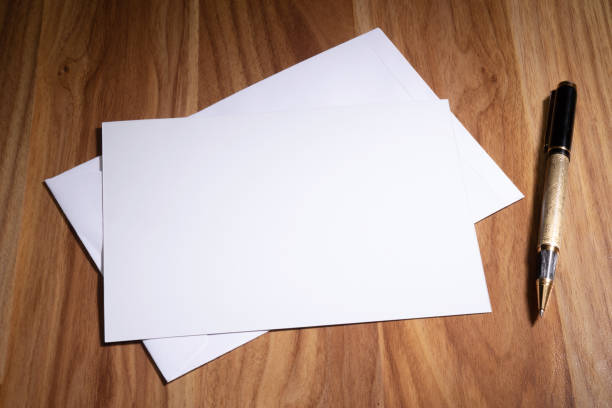 istock Blank paper with pen on wooden table 1470598045