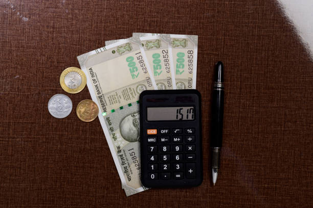 istock Indian currency note and coin with calculator 1470598048