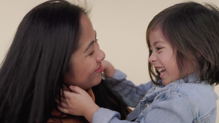 Asian family: Happy daughter and mother hugging together outdoor