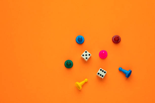 istock Colorful game chips and two dice are placed on an orange background 1470599386
