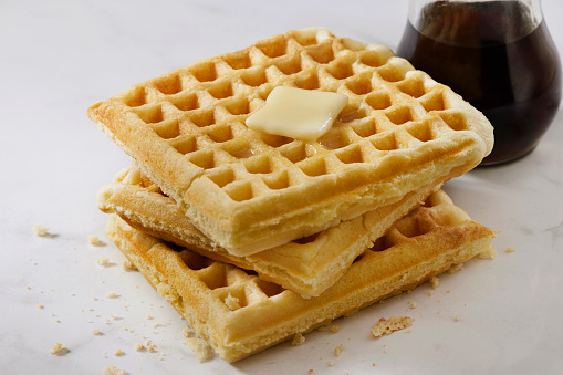 Close up of chocolate ice cream with waffle and fresh strawberry on wood table background.