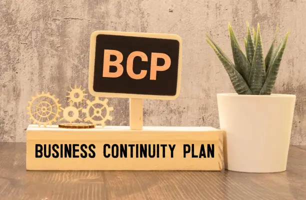 Photo of a pen, and a notebook with the text BCP Business Continuity Plan.