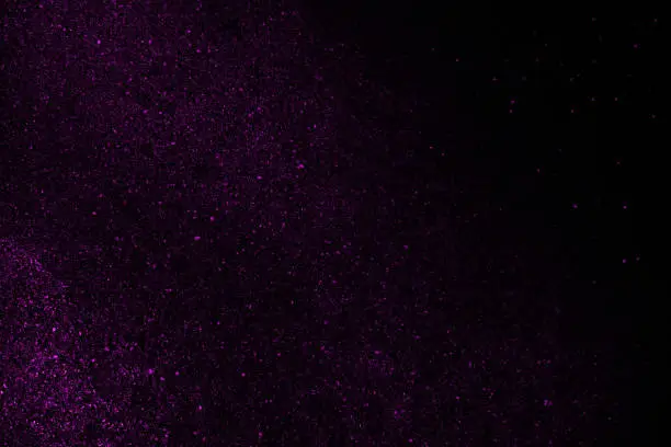 Photo of Black deep purple abstract shiny background. Glitter, sparkle, shimmer. Like outer space, the night sky with stars.