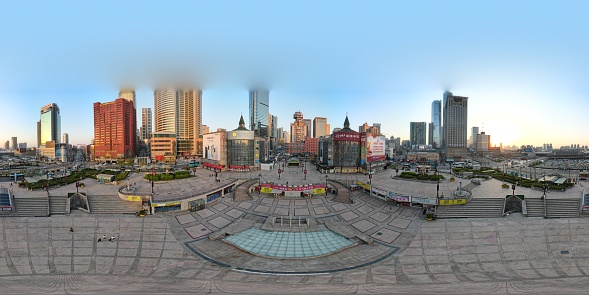 360 aerial photo taken with drone of Shengli Square in Dalian, China at sunset
