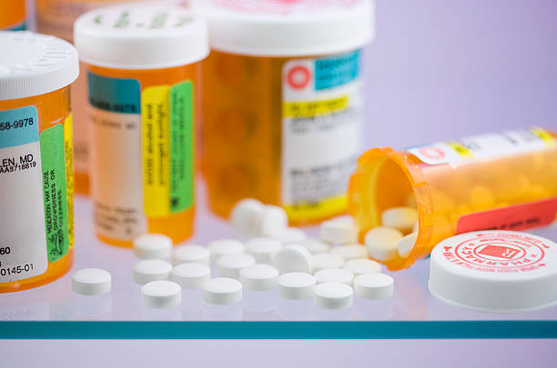 Several bottles of tablets on a glass shelf stock photo