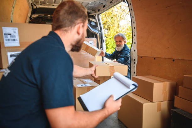 istock Young Delivery Man Sitting In Cargo Space Of Van 1470608272