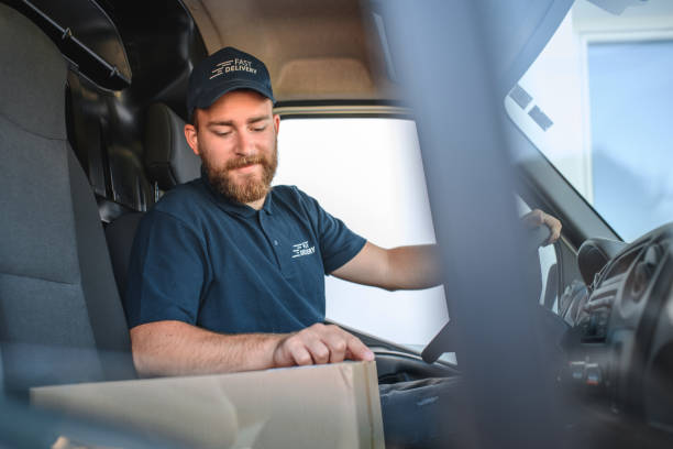 istock Young Delivery Man Sitting In Van Cockpit 1470608278