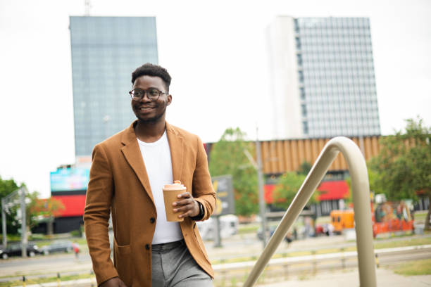 istock Young African American businessman enjoying coffee from a reusable cup 1470608545