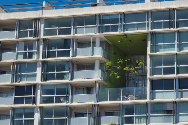 buenos aires, argentina - november 4 2022: modern architectural apartment building with a cubical space with a communal area with a tree
