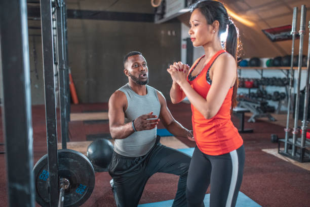istock Male instructor teaching sportswoman at gym 1470610155