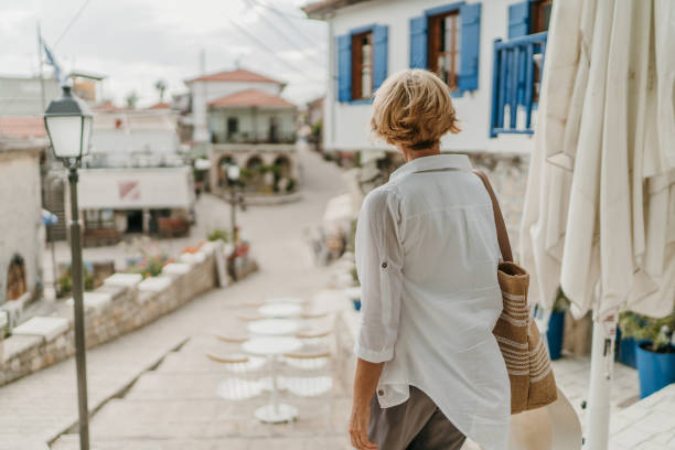 istock Woman taking a walk in small town 1470610384