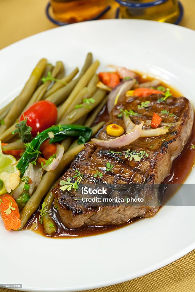 roast big steak on green dish close up roast big steak on green dish close up. Strip Steak Stock Photo