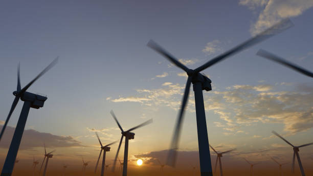 istock Wind mills at sunrise and sunset. Renewable clean energy fields. Wind turbines. 1470612113