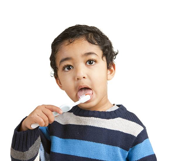 Portrait of a Toddler Brushing His Teeth, Isolated, White stock photo