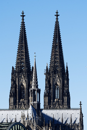 the two church towers and the crossing tower of the cologne cathedral against blue sky