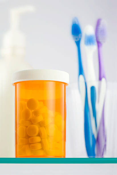 Bottle of tablets on a glass shelf stock photo