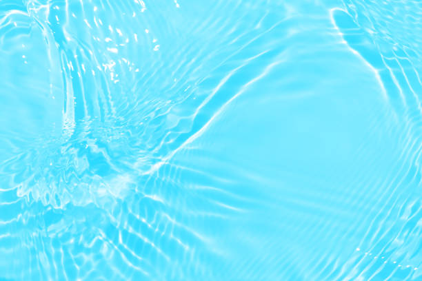 istock Defocus blurred transparent blue colored clear calm water surface texture with splashes and bubbles. Trendy abstract nature background. Water waves in sunlight with copy space. Blue watercolor shining 1470620218