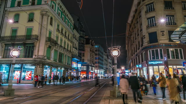 4k uhd timelapse footage of street people store at night Rue de la Croix d'Or with trams , Geneva, Switzerland
