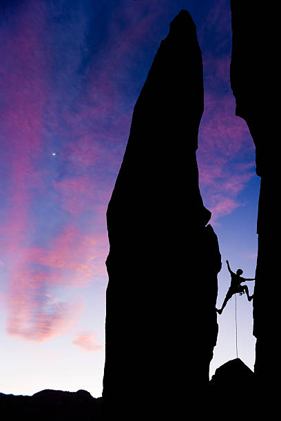 istock Rock climber reaching across a gap 147062638