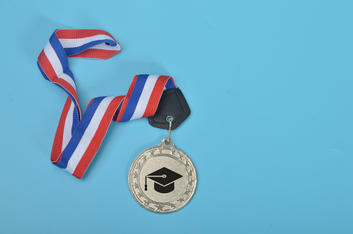 Silver medal with graduation hat symbol. Education and success concept.