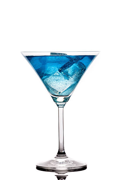 Blue drink being served by the glass on the table