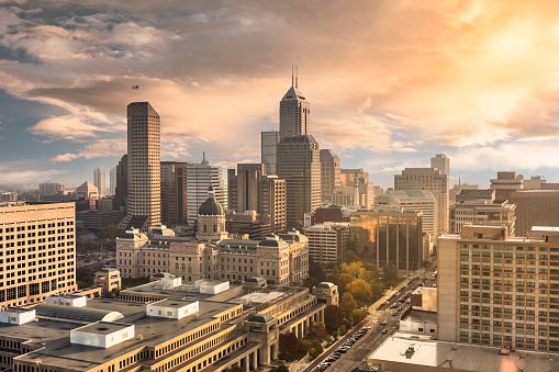 City skyline view over the downtown buildings and statehouse of Indianapolis, Indiana, USA at sunrise