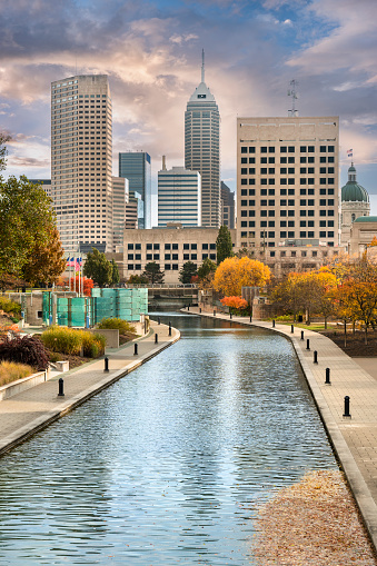 Downtown city skyline view of Indianapolis, Indiana, USA looking over the buildings and waters of the Central Canal Walk