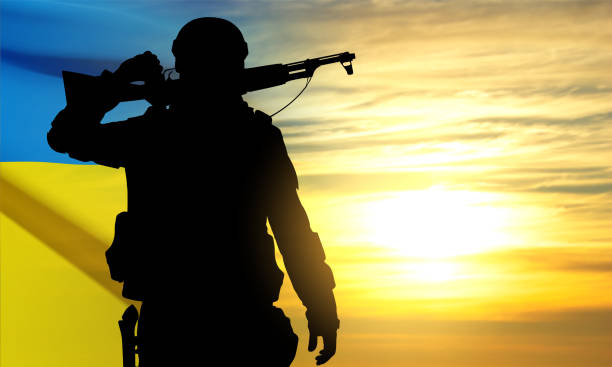 istock Silhouette of soldier with Ukraine flag 1470632306