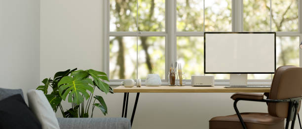 istock Minimal and comfortable home workspace in living room interior design with computer mockup 1470633944